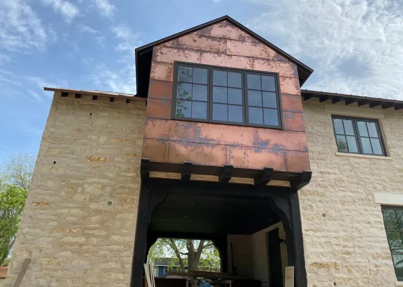 Copper metal panel facade on a stone building for Skylight Installation in Gulf Hills