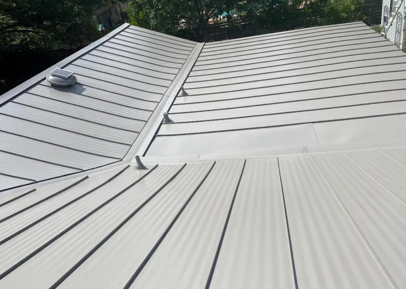 Solar attic fan installed on a metal roof for Roof Ventilation in Gulf Hills